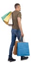 Back view of going man with shopping bags Royalty Free Stock Photo
