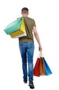 Back view of going man with shopping bags Royalty Free Stock Photo