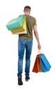 Back view of going man with shopping bags Royalty Free Stock Photo