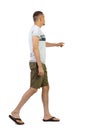 Back view of going pointing man in shorts