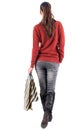 Back view of going woman with shopping bags . Royalty Free Stock Photo