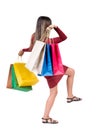 Back view of going woman with shopping bags . beautiful girl i Royalty Free Stock Photo