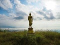 Back view of golden great buddha statue on the top of mountain Royalty Free Stock Photo