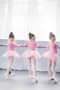 back view of graceful little ballerinas practicing ballet