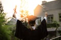 Back of view Graduate put hands up and celebrating with certificate in her hand and so proud and happiness in Commencement day Royalty Free Stock Photo