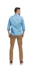 Back view of grizzled man in casual outfit looking to side