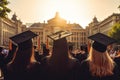 Back view of a group of graduates in cap and gowns on the background of the university, rear view graduation hats on university