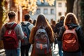 Back view of a group of students with backpacks walking in the city, Back view of a group of students with backpacks walking on