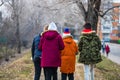 Back view, group of teenagers walking on the alleys of park in Targoviste, Romania, 2020