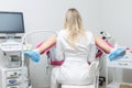 Back view of a gynecologist conducting a routine examination of a girl on a gynecological chair using modern medical Royalty Free Stock Photo