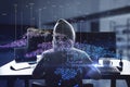 Back view of hacker using computers at desktop with abstract digital map and index lines on blurry interior background. Global Royalty Free Stock Photo