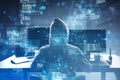 Back view of hacker using laptop at desk with creative binary coding hologram on blurry background. Software programming code and Royalty Free Stock Photo