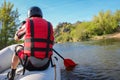 Back view of a hand with red paddle rafting on the river Royalty Free Stock Photo