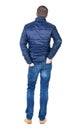 Back view of handsome man in blue windcheater looking