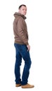 Back view of handsome man in brown windcheater looking up. Royalty Free Stock Photo