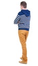 Back view of handsome man in striped hooded sweater.