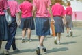 Back view of happiness primary girl students in pink shirt and blue skirt walk to classrooms