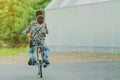 Back view of happiness two brothers wear military camouflage shirts ride bicycle