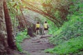 Back view of happiness two female friends in identical clothes walking along hiking trail path Royalty Free Stock Photo