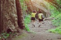 Back view of happiness two female friends in identical clothes walking along hiking trail path Royalty Free Stock Photo