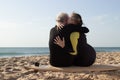 Back view of happy aged couple kissing on surfboard Royalty Free Stock Photo