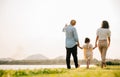 Back view of Happy Asian family walking and playing together in a scenic garden Royalty Free Stock Photo