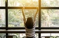 Back view of happy asian woman enjoying and freedom with open hands,Female rise hands up enjoy nature indoor Royalty Free Stock Photo