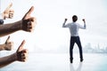 Back view of happy european businessman with thumbs up celebrating success on light city background. Happiness and successful Royalty Free Stock Photo