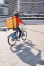 Courier with yellow backpack driving bike and coming to the client with parsels