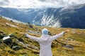 Back view of happy woman enjoying freedom with arms outspread in Royalty Free Stock Photo