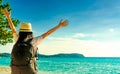 Back view of happy young Asian woman in casual style fashion with straw hat and backpack. Relax and enjoy holiday at tropical Royalty Free Stock Photo