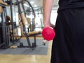 Back view of healthy young man holding dumbbell at sport gym. Fitness and workout concept Royalty Free Stock Photo