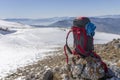 Back view of a hiker looking at the view from a snowy mountain peak Royalty Free Stock Photo