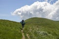 Back view of hiker man with big backpack walking in mountains Royalty Free Stock Photo