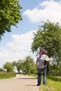 Back view of a hitchhiker on a road