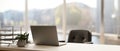 Back view image of a modern minimal bright office with a laptop computer on a white desk Royalty Free Stock Photo