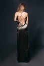 Incognito blondie with nude shoulder posing at long dress. Royalty Free Stock Photo