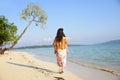 Back view of indian woman walking across beach Royalty Free Stock Photo