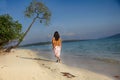 Back view of indian woman walking across beach Royalty Free Stock Photo