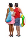 Back view of a an international couple with an inflatable circle