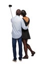 Back view of an interracial couple that makes selfie on selfie s Royalty Free Stock Photo