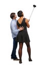 Back view of an interracial couple that makes selfie on selfie s Royalty Free Stock Photo