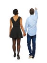 Back view of interracial going couple who points somewhere Royalty Free Stock Photo