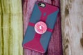 Back view of an iPhone enclosed in a case with a PopSocket attached to it. PopSockets help Smartphone users grip phones better Royalty Free Stock Photo