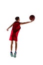 Full-length portrait of boy, basketball player training, throwing ball into the basket isolated over white background