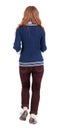 Back view of jumping woman in dark-red jeans. Royalty Free Stock Photo