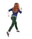 Back view of jumping woman in jeans. Royalty Free Stock Photo