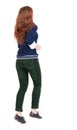 Back view of jumping woman in jeans. Royalty Free Stock Photo