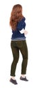Back view of jumping woman in jeans. Royalty Free Stock Photo