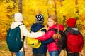 Back view of kids group stand close with rucksacks Royalty Free Stock Photo